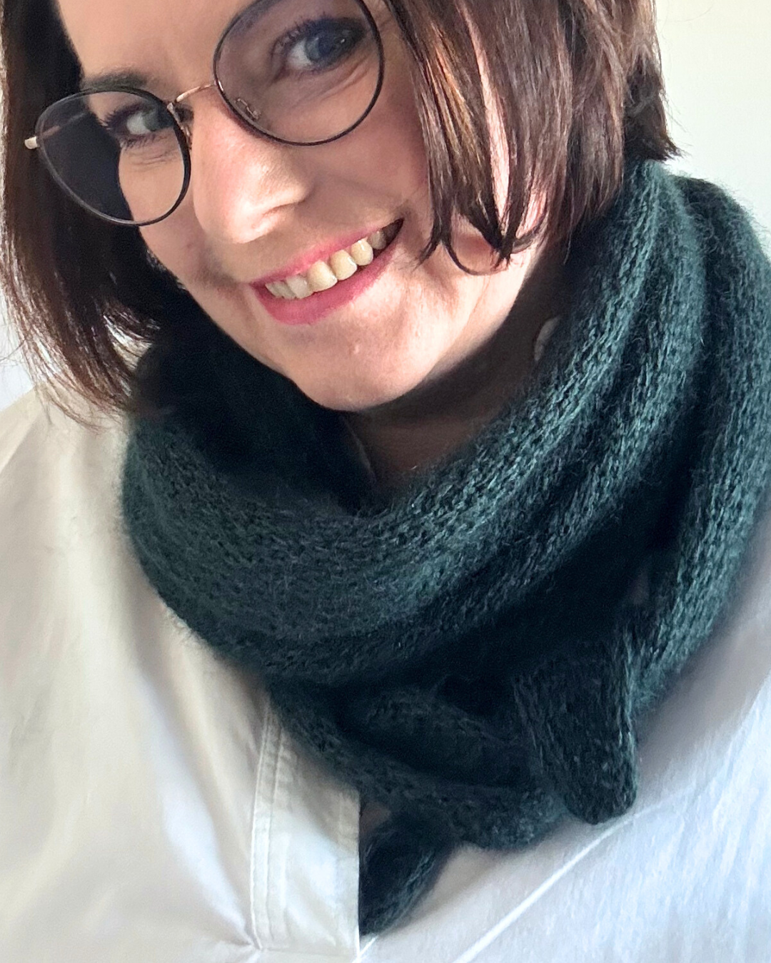 Detailansichten von Lyn Embrace in dunkelgrün – verschiedene Tragevarianten des mittelgroßen Schals.
